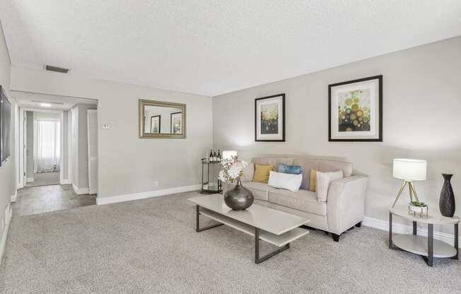 a living room with a couch and a coffee table at Summerwood Apartments, California, 95050