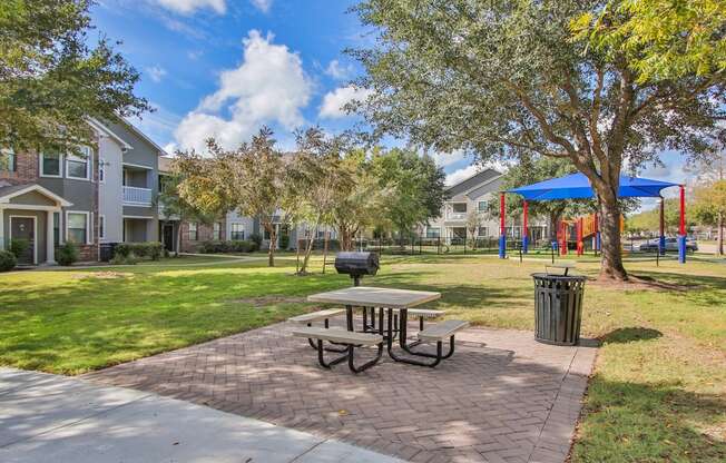 our apartments have a picnic table and a playground at Sladestone Shadow Creek, Pearland, TX, 77584