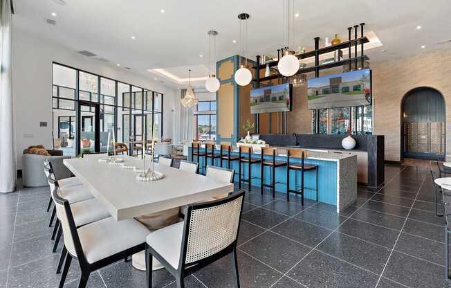 A modern dining room with a long table and chairs.
