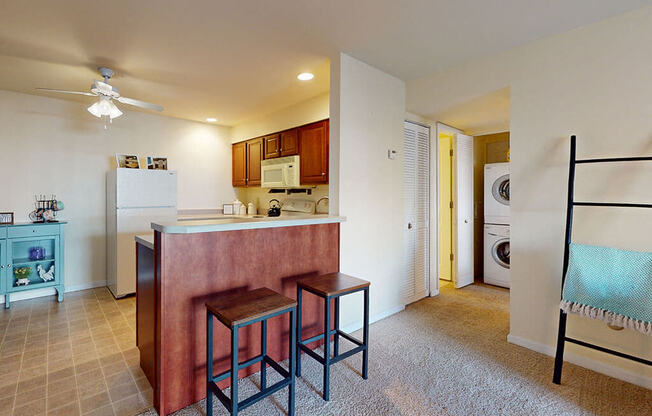 a kitchen with a counter and three stools