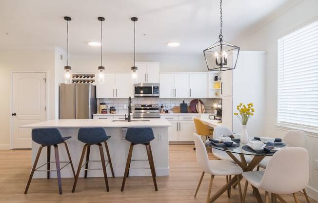 a kitchen and dining area with a table and chairs