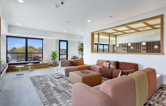 A living room with a large window and a view of trees outside.
