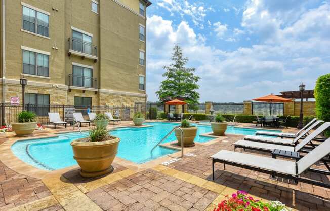 our apartments have a resort style pool and lounge chairs