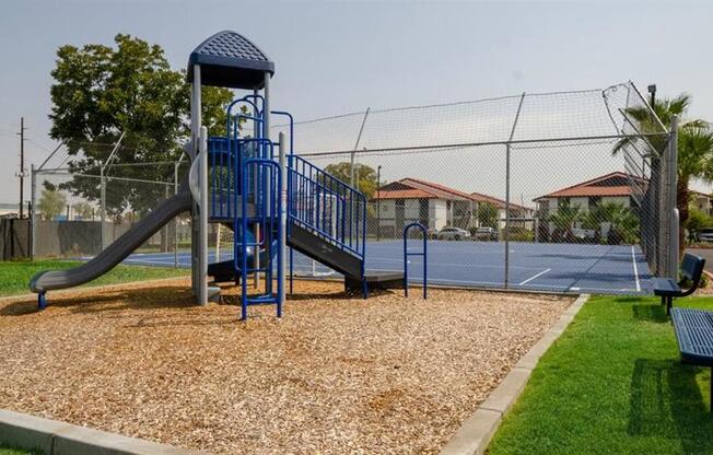 Apartments for Rent in Mesa, AZ - Mesa Station - Large Playground with Slide and Bench Seating