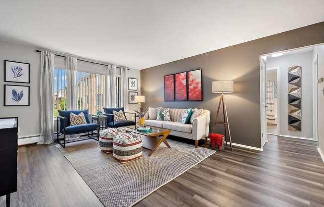 spacious living room with wood flooring and windows at the reserve apartments