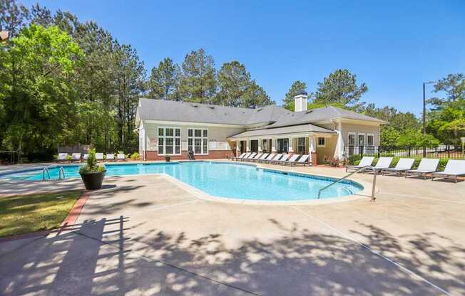 A house with a pool in front of it.