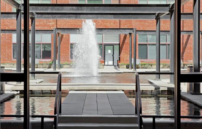 a large fountain in the middle of a building at Tindeco Wharf, Baltimore, MD