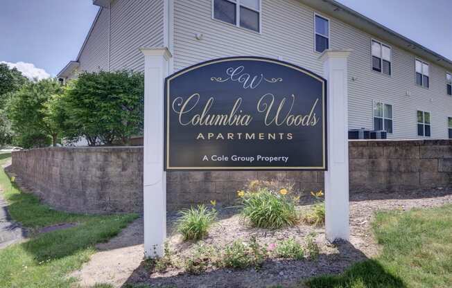 a sign apartments in front of a house