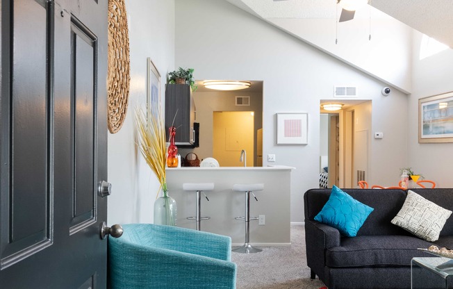 a living room with a couch and a chair and a closet