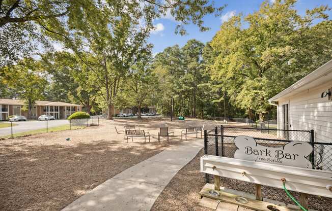 a park bench in front of a park with trees at Shellbrook, Raleigh, North Carolina