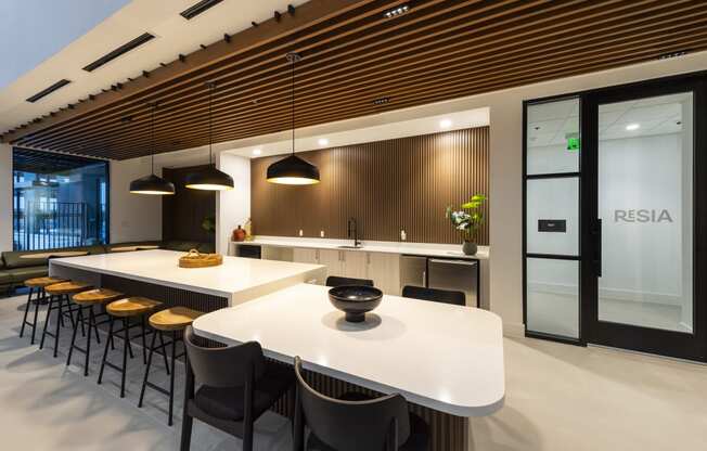 a large kitchen with a white table and chairs