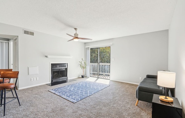 a living room with a fireplace and a sliding glass door