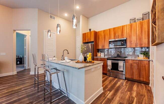 A kitchen with wooden cabinets and a white island.