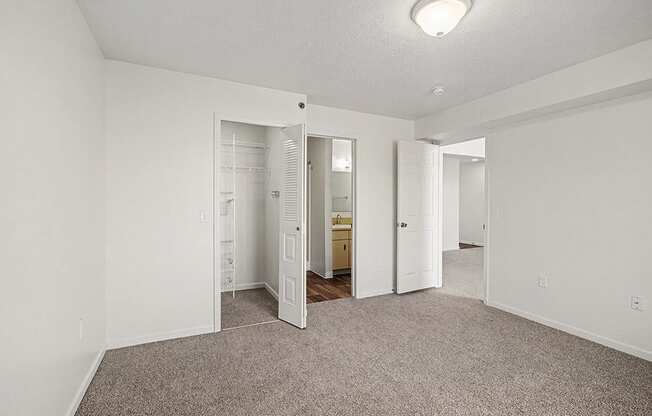 A room with a carpeted floor and white walls.
