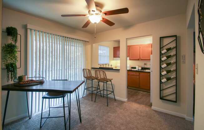 This is a photo of the dining area of the 550 square foot 1 bedroom, 1 bath, balcony floor plan model apartment at College Woods Apartments in Cincinnati, OH.