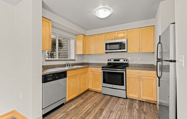 A kitchen with wooden cabinets and stainless steel appliances.