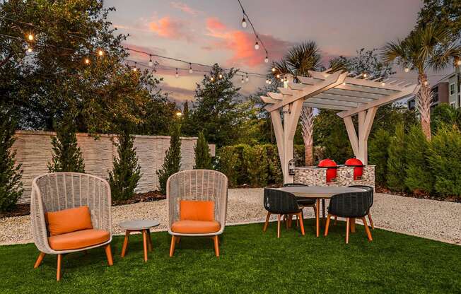 a backyard patio with a table and chairs and a pergola