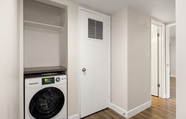 a laundry room with a washer and dryer in it