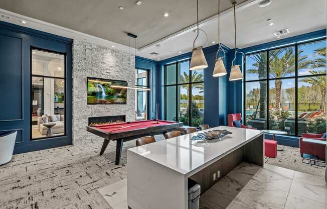 a game room with a pool table and blue walls at Altis Grand Suncoast, Florida, 34638