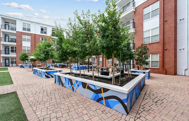 Modern outdoor seating area with decorative planters at The Grand at Upper Kirby apartments in Houston, TX