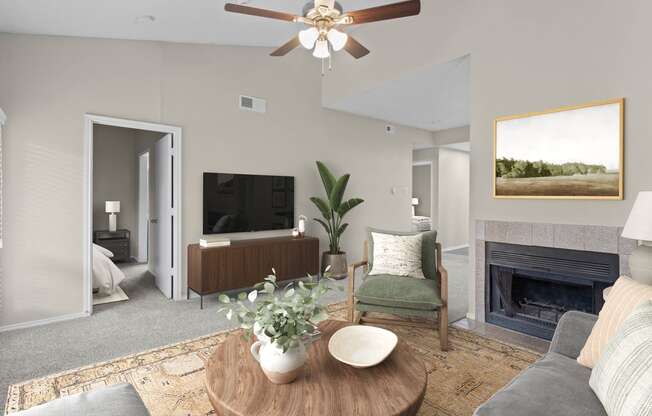 a living room with a ceiling fan and a fireplace