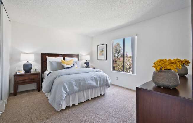 a bedroom with a bed and a dresser and a window