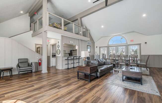 A community room with vinyl plank flooring and large windows at The Crossings Apartments in Grand Rapids, MI