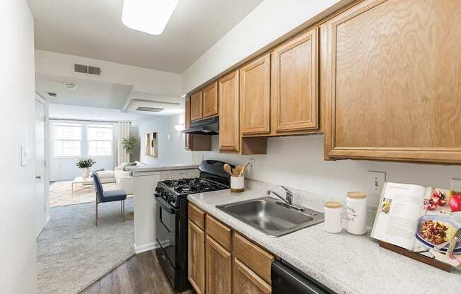 A kitchen with wooden cabinets and a black stove top oven.