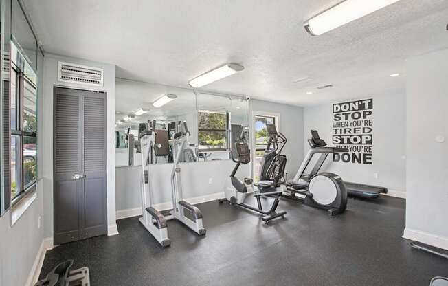 A gym with a sign that says "Don't stop when you're tired, you're done.".