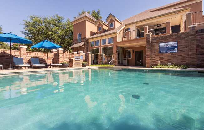 This is a photo of the pool area at The Brownstones Townhome Apartments in Dallas, TX.