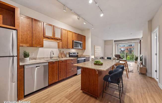 A kitchen with wooden cabinets and a stainless steel refrigerator.
