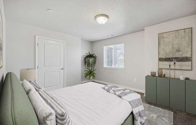 a white bedroom with a white bed and a green couch