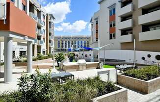 a courtyard with a fountain and seating area at Main Street Lofts Cupertino