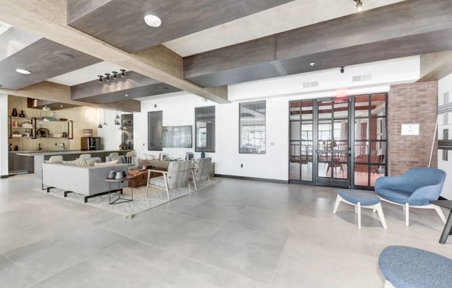 the lobby of a building with a living room and a kitchen