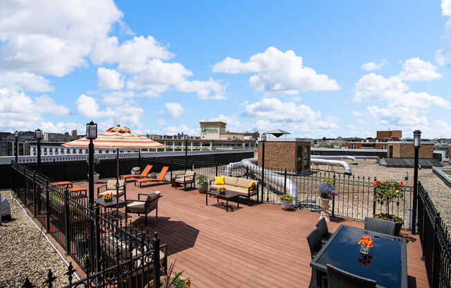 a roof deck with furniture and a view of the city