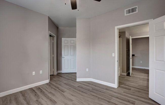 an empty room with a ceiling fan