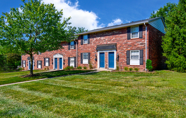 Exterior view of Ashton Brook Apartments, showcasing the building's architecture and surrounding landscaping.