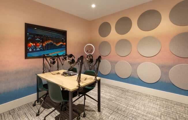 a conference room with a table and chairs and a wall with circles on the wall