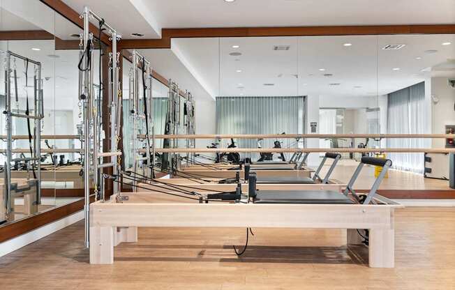 A pilates studio with mirrors on the wall.