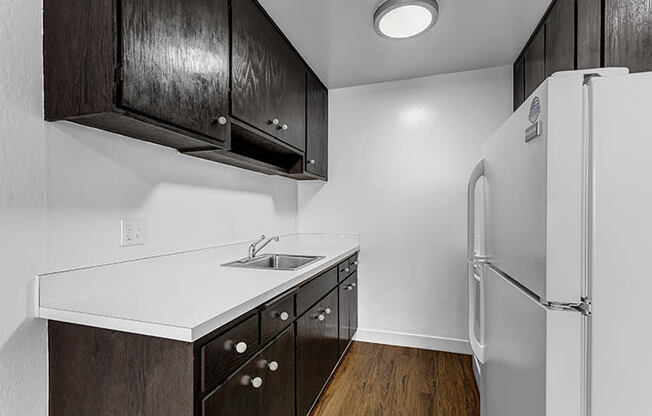 a kitchen with a refrigerator and a sink