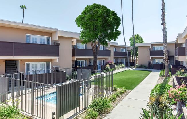 a house with a fence in front of a building