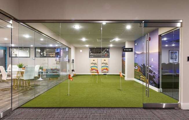 a room with a green carpet and glass doors