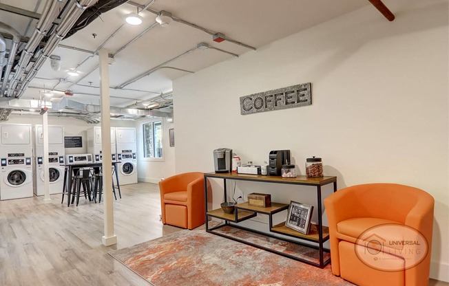 a sitting area in the laundry center room with coffee.