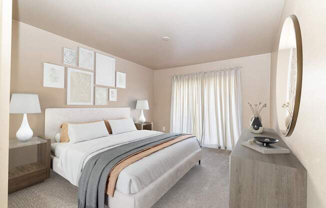 A bedroom with a large bed and a round mirror on the wall.