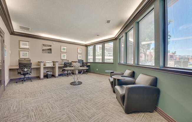 A conference room with a table, chairs and pictures on the wall.
