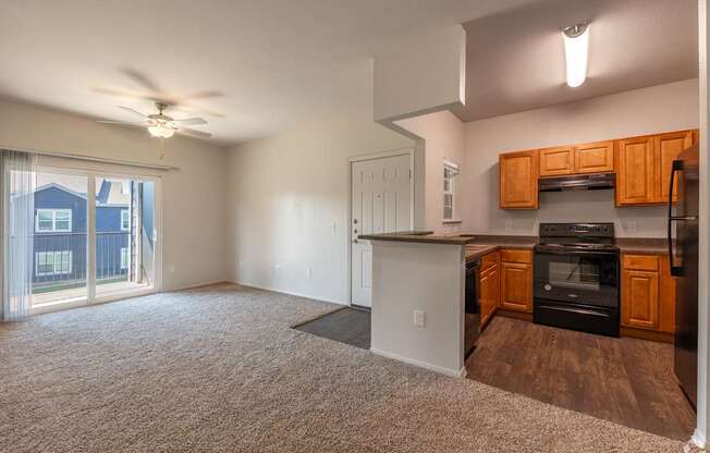 A well lit kitchen with a refrigerator, oven, and microwave.