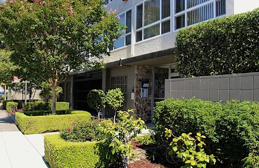 Front of 36th ave Apartments a building with large windows facing the street side