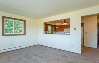 an empty living room with a large window