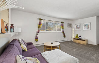 a living room with a purple couch and a table