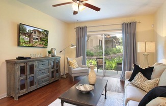 TV, coffee table, couch, and chair in a living room at Legacy, Tampa, FL